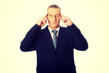 Pensive businessman touching head