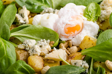 Spinach salad with egg benedict