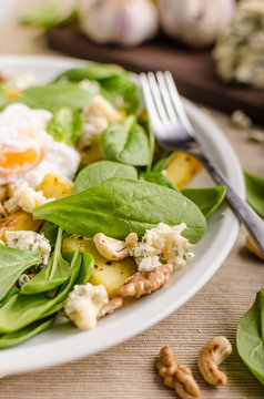 Spinach salad with egg benedict