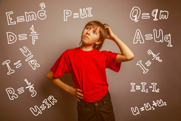 European-looking boy of ten years thinking, scratching his head 