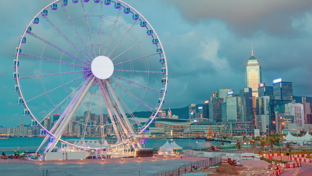 Timelapse video of skycrapers and ferris wheel in Hong Kong at twilight, camera zooming in