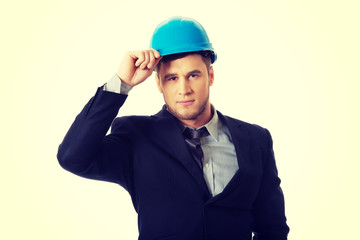 Happy businessman with blue hard hat.