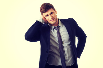 Annoyed businessman covering his ear.