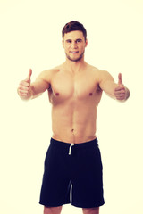 Fototapeta premium Sexy muscular man showing thumbs up.