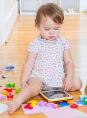 Toddler girl using a tablet computer