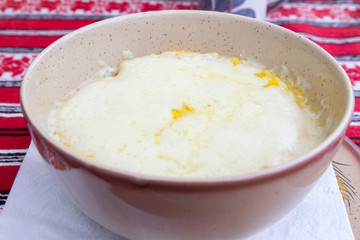 Romanian traditional plate of cheese and polenta over traditional, rural tablecloths