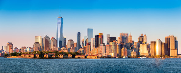 Downtown New York skyline panorama with Ellis Island in the foreground - obrazy, fototapety, plakaty