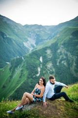 beautiful young couple in love in the mountains