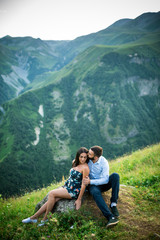 beautiful young couple in love in the mountains