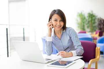 Asian Businesswoman sitting at her desk in an office