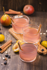 Homemade fruit compote with cinnamon on rustic wooden table. Selective focus