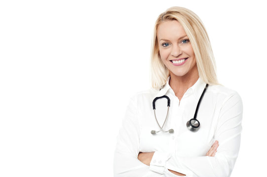 Smiling pretty doctor posing over white