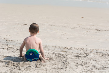 baby playing on beach