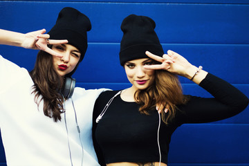 Two young hipster girl friends together having fun. 