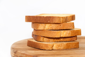 Tower of crunchy bread toast on the wooden board
