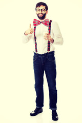 Man wearing suspenders with glass of milk.