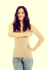 Beautiful young woman pointing somewhere.