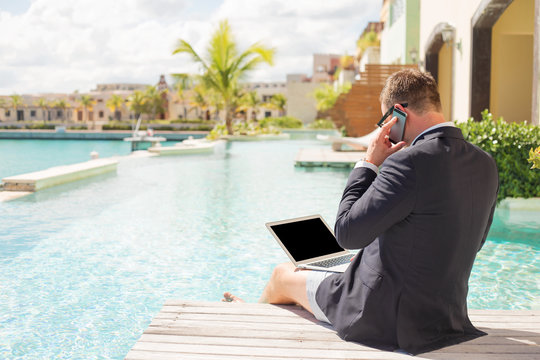 Businessman Working By The Pool