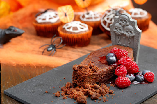 Chocolate cake with fruit in shaped coffin on Halloween day