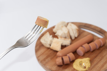 Hot dog with mustard on the fork