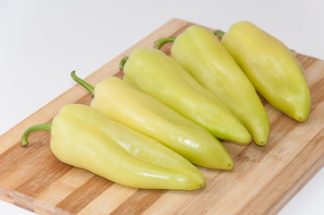 Green paprika on the cutting wooden board