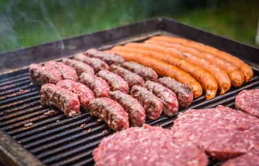 Grilling Meat on barbecue grill with coal.