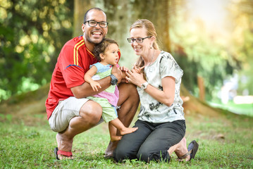 Happy interracial family is enjoying a day in the park