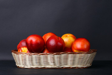 peaches in a basket on a black background