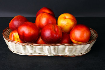 peaches in a basket on a black background