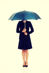 Business woman is holding blue umbrella. 