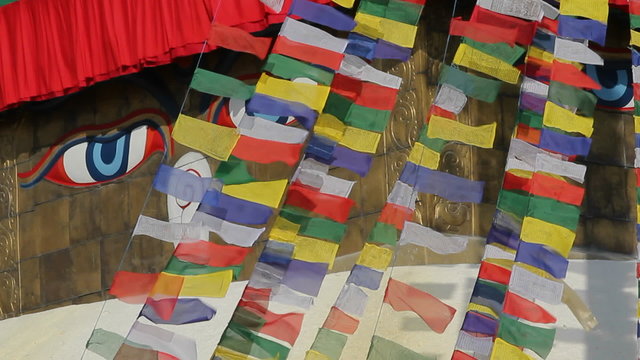 Prayer flags streaming  in front of Adi Buddha