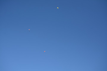 Three small parachuts  in the sky