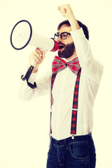 Man wearing suspenders with megaphone.