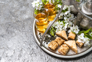 Tea glasses and pot, traditional sweets. Islamic holidays. Eid a