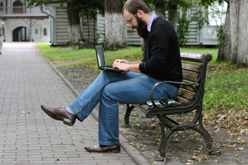 man reading books in the park