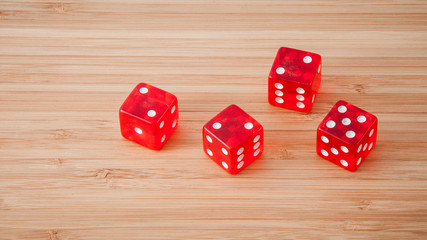 red dice on a wooden background