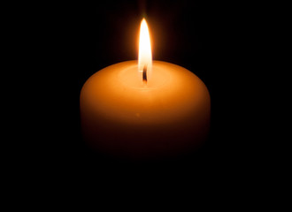 Burning candle in the night