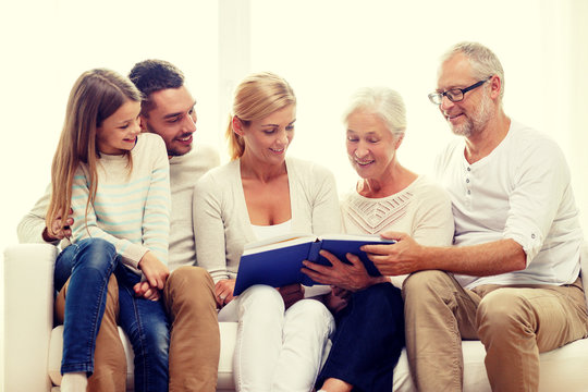 happy family with book or photo album at home