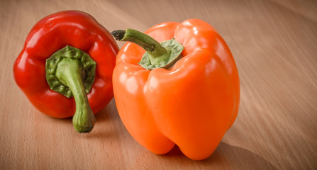 Fresh orange and red peppers on a cutting board