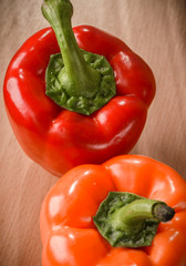 Fresh orange and red peppers on a cutting board