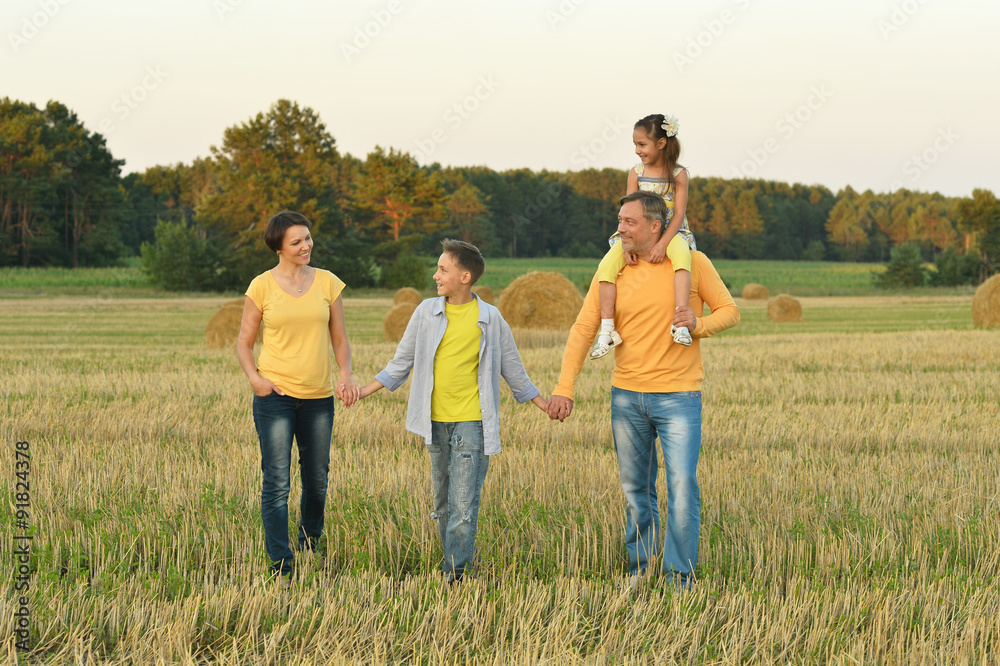 Wall mural Happy family in wheat field