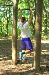 Man practice fitness in forest.