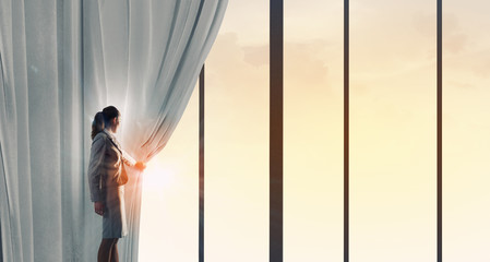 Woman open curtain