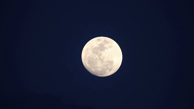 A full moon rises.