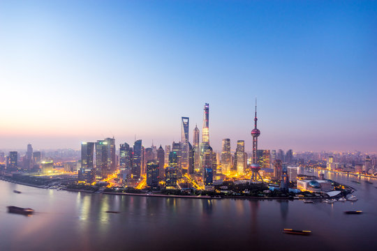 skyscrapers of the city in China around a river at dusk © zhu difeng