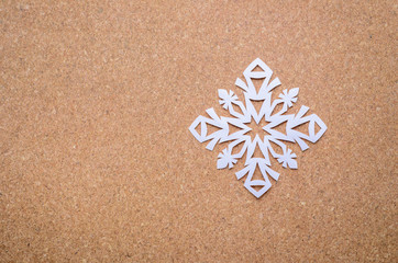 Fototapeta na wymiar paper textured background with a white snowflake
