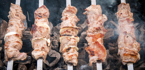 grilled skewers on coals with smoke