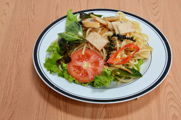 stir-fried spicy spaghetti with slice sausage Thai fusion food