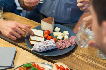 Closeup of man picking cheese slice