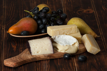 Assorted Cheese On Slate Stone. Grapes, Pears